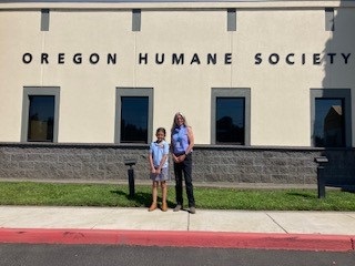 Emerie and Sharon Harmon stand in front of the Oregon Humane Society building.
