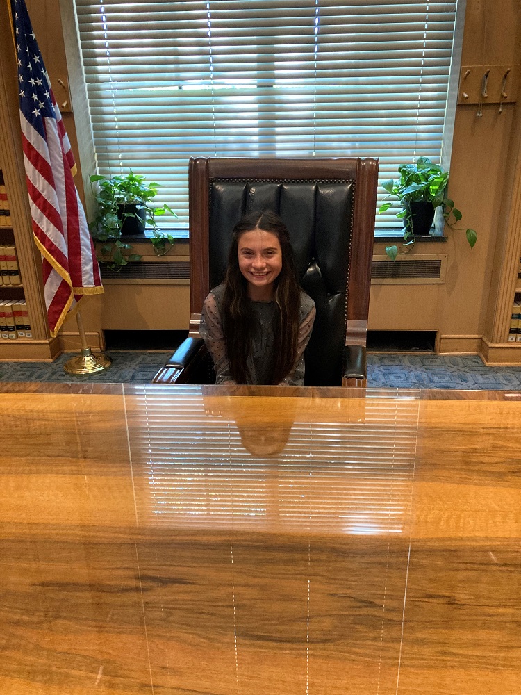 Lea at the desk where ceremonial signings happen in the Governor’s Ceremonial Office.